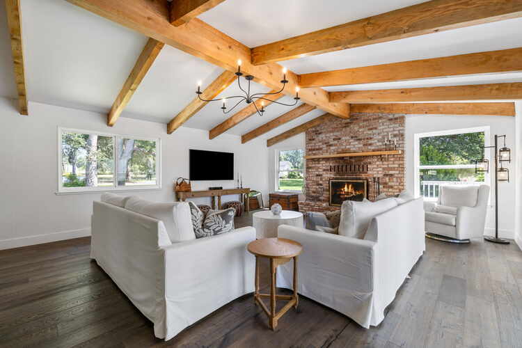 Living room with fireplace and beamed ceiling