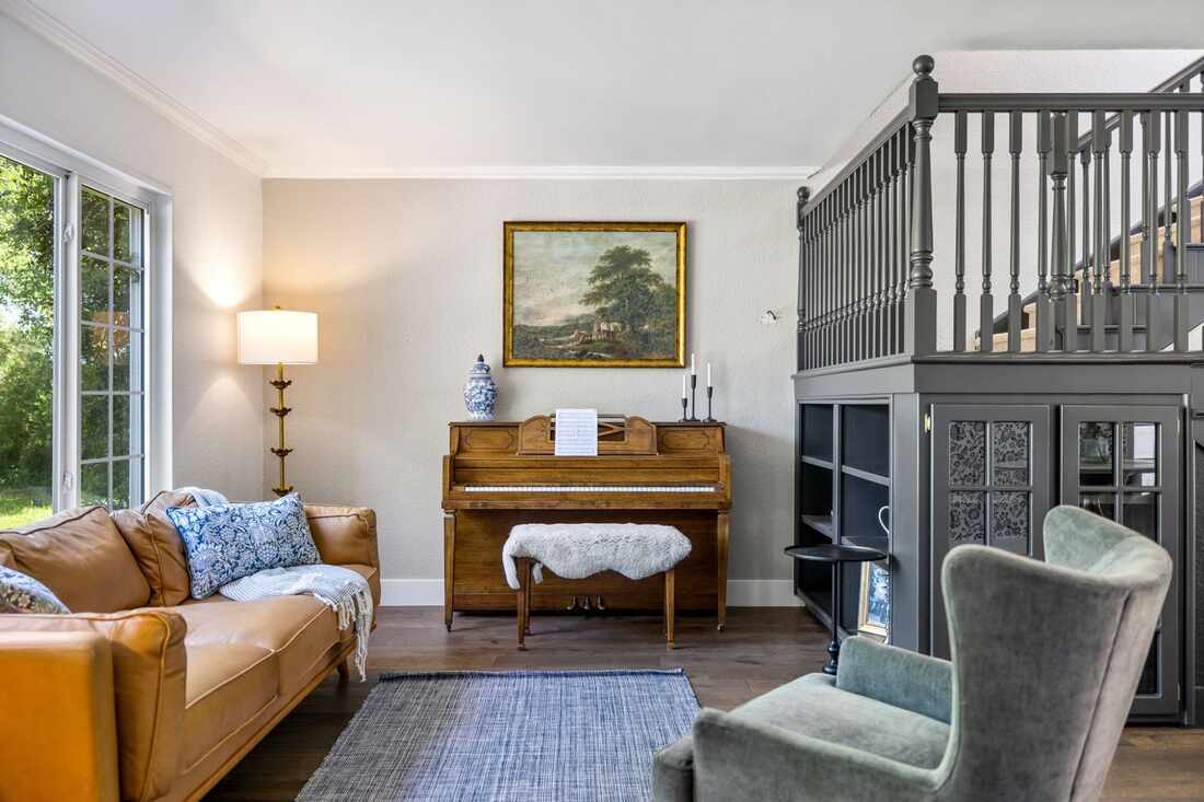 Living room with piano and meadow views