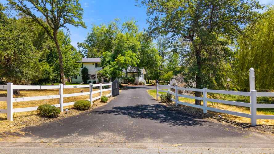 White fence driveway approach to the farmhouse